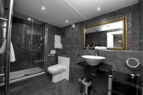 a bathroom with a toilet and a sink and a shower at Garden Mews - 2 double bedrooms - Harrogate Holiday Apartments in Harrogate