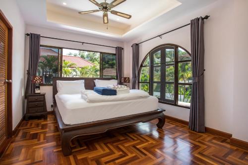 a bedroom with a bed and a large window at Best Holidays - Oxygen pool, Billard, Gym! 2-Storey Tropical Villa Havana N in Kamala Beach
