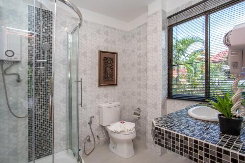 a bathroom with a toilet and a glass shower at Best Holidays - Oxygen pool, Billard, Gym! 2-Storey Tropical Villa Havana N in Kamala Beach