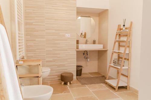 a bathroom with a sink and a toilet and a mirror at [ApuliaLux] Marietta Luxury House - Centro Storico in Brindisi