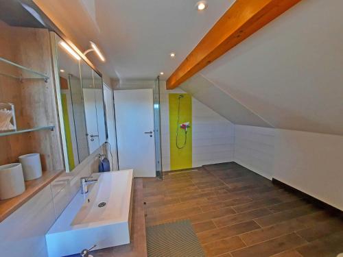 a bathroom with a sink and a yellow door at Ferienwohnung Auszeit Objekt ID 13178-9 in Waren