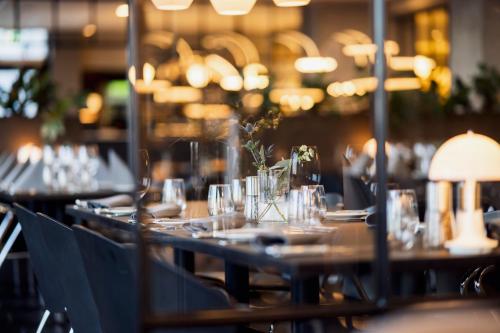 a long table with plates and glasses on it at Best Western Plus Hotel Fredericia in Fredericia