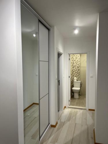 a bathroom with a toilet and a glass door at Kati apartments in Varna City