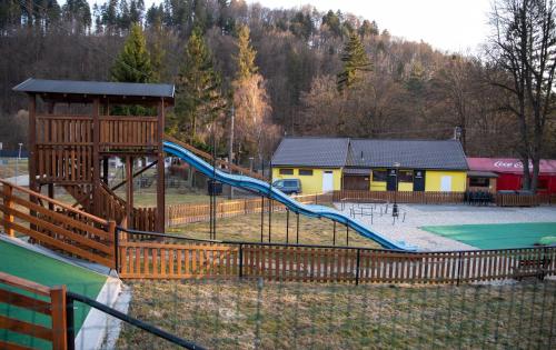 a playground with a slide in a park at Chata U dědka in Prostřední Bečva
