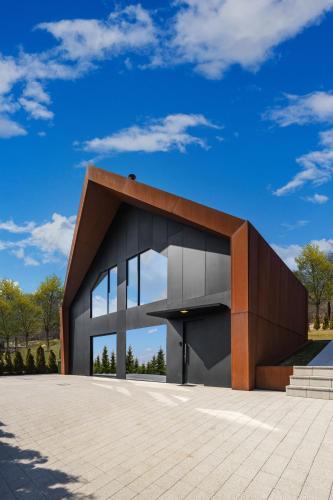 a modern building with a blue sky in the background at Zerm Holiday House with pool, jacuzzi & sauna - Gorski kotar in Mrkopalj