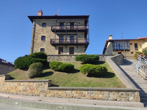 a large stone building with bushes in front of it at Harritarte in Getaria