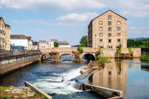 an old bridge over a river in a city at Befani's Mediterranean Restaurant & Townhouse in Clonmel