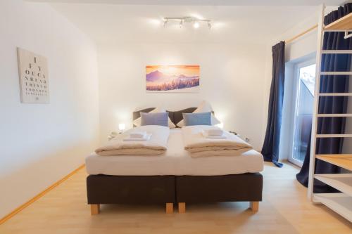 a bedroom with a large bed in a room at The Steinbock Lodge with garden and bbq in Zell am See