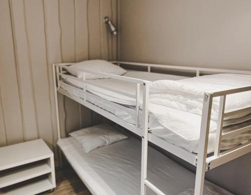 a white bunk bed in a small room at Havets Magasin in Väjern