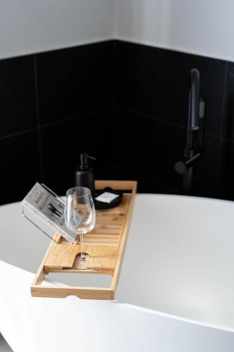 a wooden tray with a wine glass on a table at Downtown Loulé in Loulé