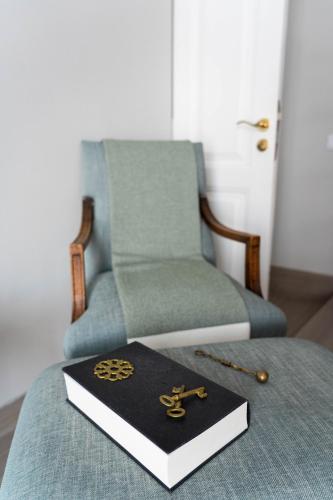 a book on top of a bed with a chair at Downtown Loulé in Loulé