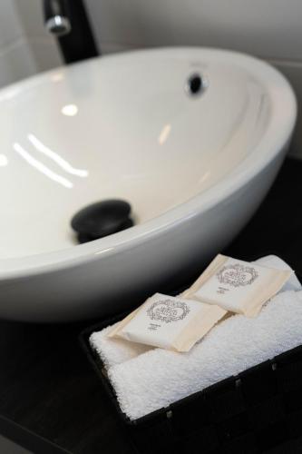a bathroom with a white sink and two folded towels at Downtown Loulé in Loulé