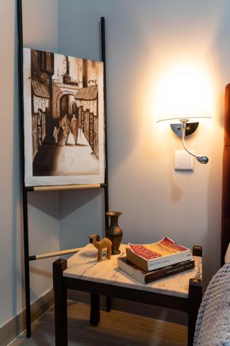 a table with books on it next to a lamp at Downtown Loulé in Loulé