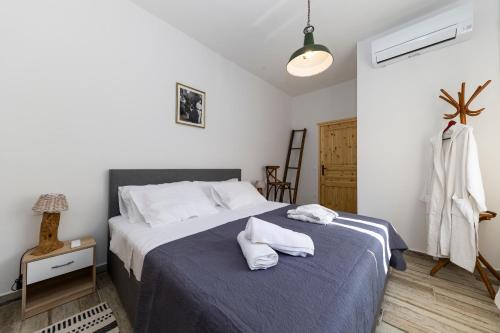 a bedroom with a bed with two towels on it at Villa Maza in Ždrelac