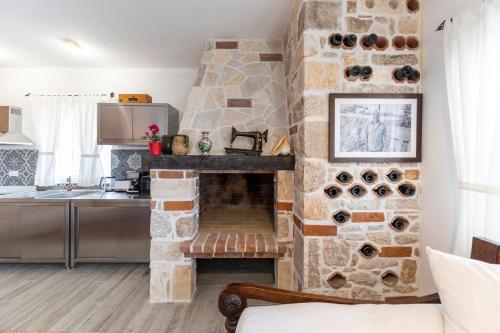a kitchen with a stone fireplace in a room at Villa Maza in Ždrelac