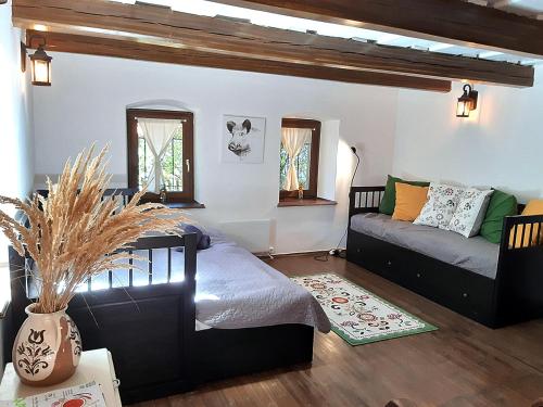 a living room with a bed and a couch at Wild Boar Cottage - Romantic getaway in Badacsonytomaj