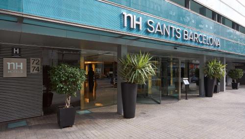 a store front with potted plants in front of it at NH Sants Barcelona in Barcelona