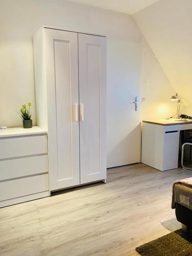 a room with a white cabinet and a sink at Georgenberg in Spremberg