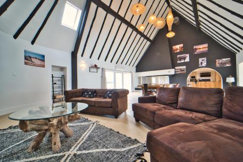 a living room with a couch and a table at La Cabane du Boumian in Saintes-Maries-de-la-Mer