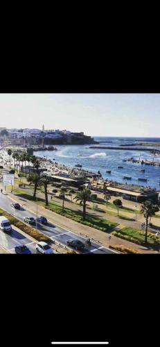 a view of a beach with cars and the water at Dar Lalla Aicha in Rabat