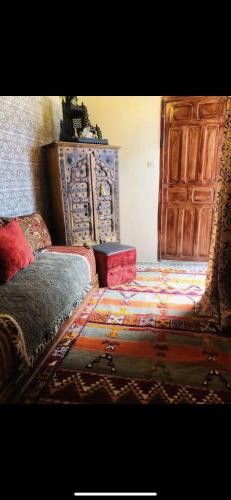 a bedroom with a bed and a large wooden door at Dar Lalla Aicha in Rabat