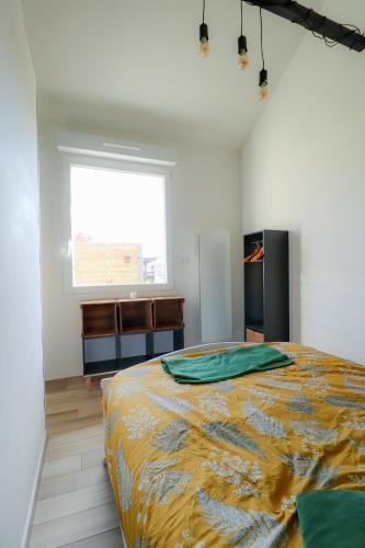 une chambre avec un lit et une fenêtre dans l'établissement Gîte Les Mouettes, à Verton