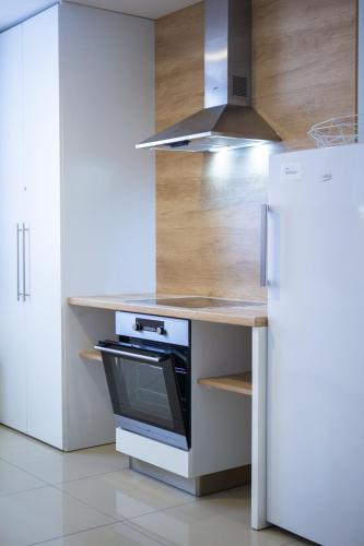 a kitchen with a stove and a refrigerator at Chaty Ferrata in Martin