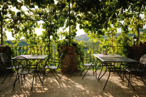 two tables and chairs sitting under a tree at Glamping Senesalina in Kojsko