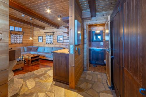 a living room in a log cabin with a couch at Holiday Village Tahko-Tours in Tahkovuori