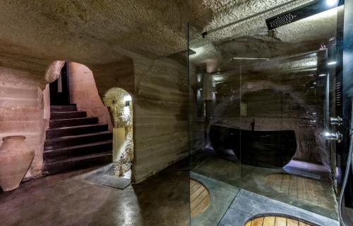 a room with a glass door and a stair case at Carus Cappadocia in Goreme