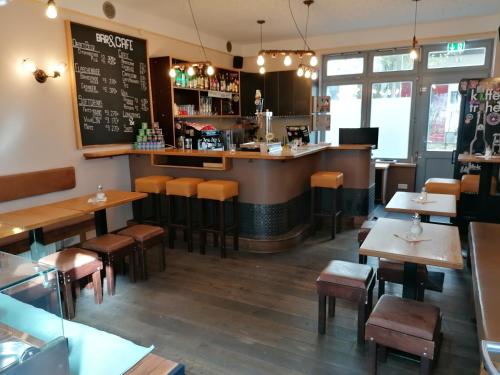 a restaurant with tables and chairs and a bar at Backpackers St. Pauli in Hamburg