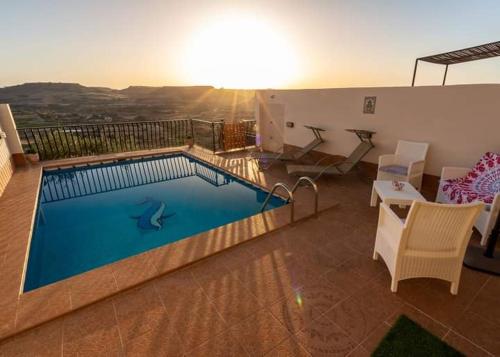a swimming pool in the middle of a living room at Namaste Valley Gozo in Il-Pergla