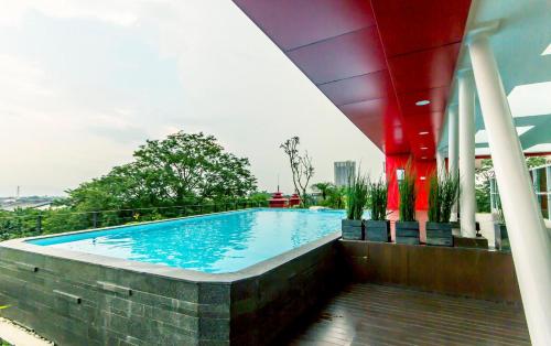 a swimming pool on top of a building at Grand Cordela Hotel Bandung in Bandung