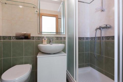 a bathroom with a sink and a toilet and a shower at Marija F2 Apartment in Krk