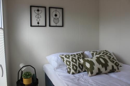 a living room with a couch and two pictures on the wall at Marina Houses in Ruciane-Nida