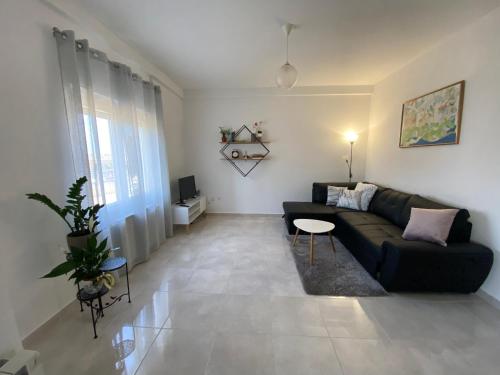 a living room with a black couch and a table at Villa Nina Poreč in Poreč