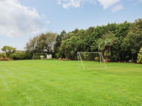 a field with two soccer goals in the grass at Sutton Cottage in Broadway