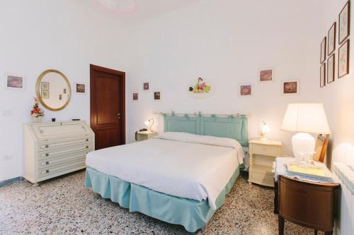 a bedroom with a bed and a dresser and a mirror at Country Hotel Vessus in Alghero