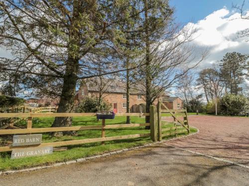 a wooden fence in front of a building at The Red Barn in Longframlington
