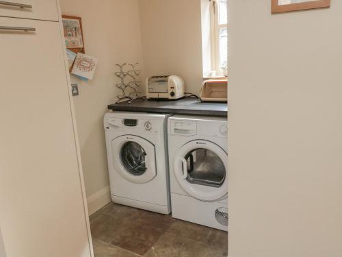 a laundry room with a washer and dryer at The Red Barn in Longframlington