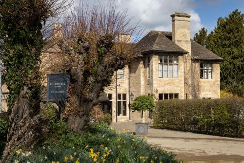 a brick house with a sign in front of it at The William Cecil in Stamford