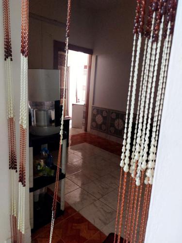 a kitchen with a bunch of beads hanging on a wall at Homestay 3 in Dhaka