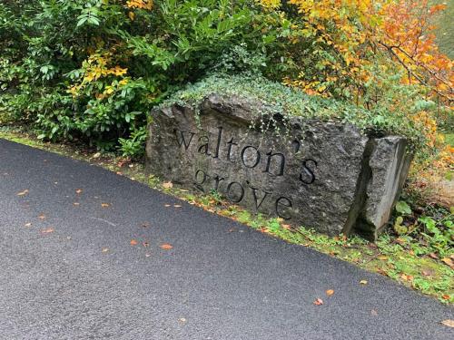 a stone sign on the side of a road at Mount Juliet luxury residence in Ballylinch Bridge