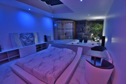 a bedroom with a pink bed and a tv at Jacuzzi Romantique 15 min Etretat 2 in Fécamp