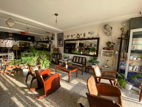 a living room with a lot of chairs and tables at Hotel La Piazzetta in Mérida