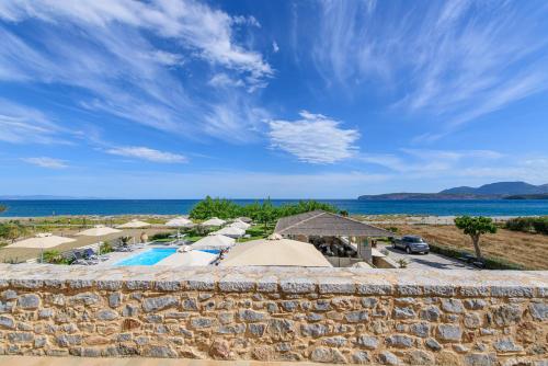 a view of a resort with a pool and umbrellas at Castello Antico Hotel in Gythio
