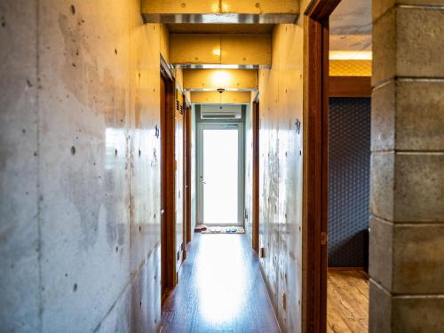 a hallway of a building with wooden floors and walls at Kugani-YA. in Kin