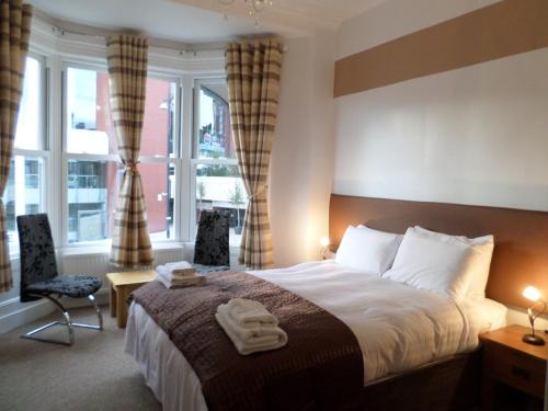 a hotel room with a bed and a window at The Camberley in Harrogate