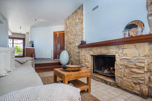 a living room with a large stone fireplace at Luxury Villa with panoramic views over Moraira in Teulada