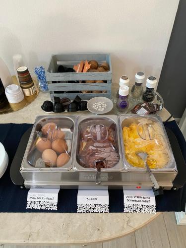 a tray of eggs and other food on a table at B&B La Terrazza in Pozzolengo